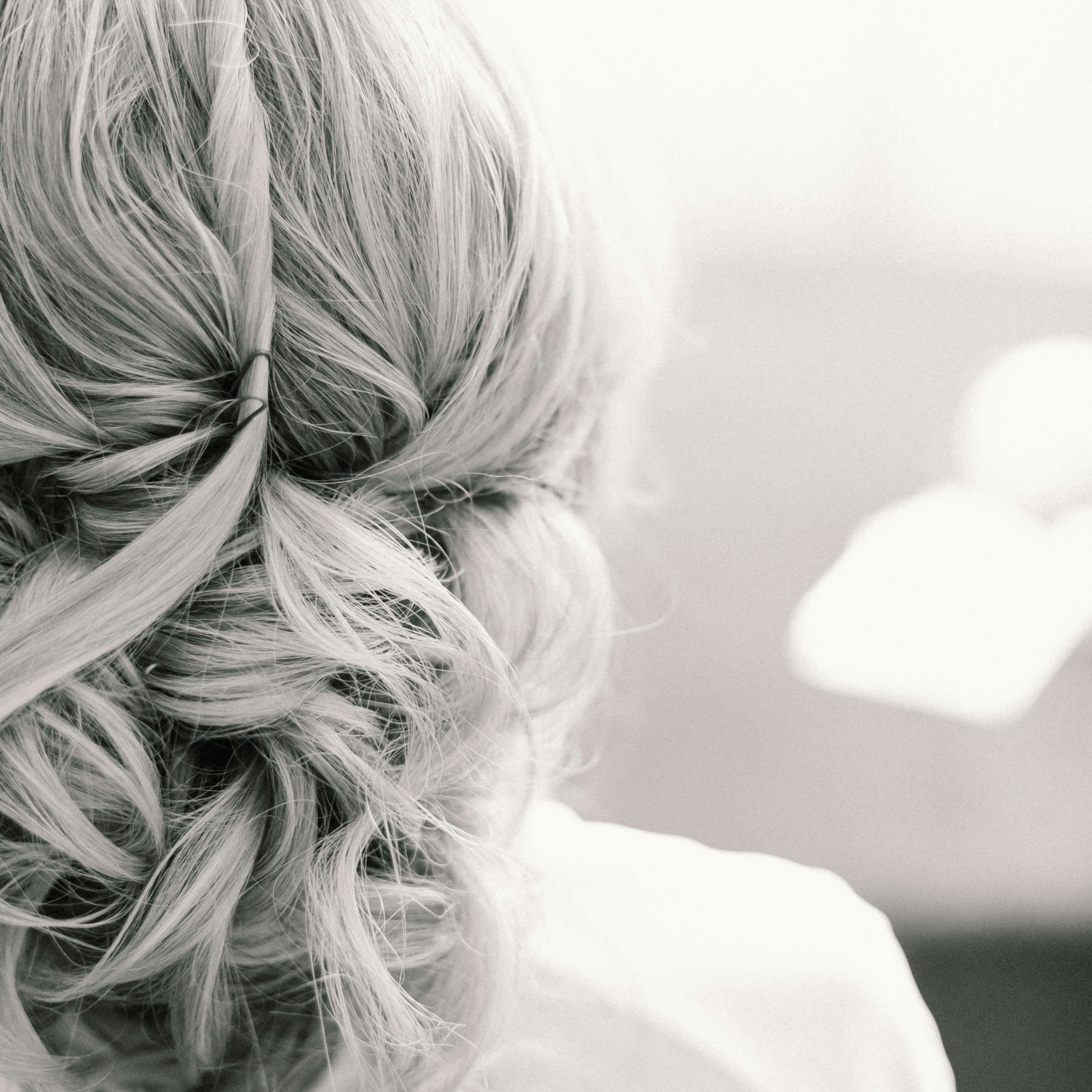 Detailaufnahme einer eleganten Hochsteckfrisur mit blondem Haar – Sichtbares Volumen und Fülle durch professionelle Haarverdichtung und Extensions von Rovia Hair Basel.